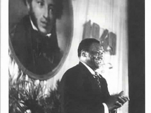 African American man standing at a podium in Russia